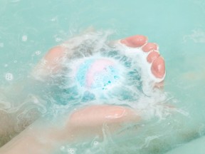 Bath ball in female hands close up in the water. Getty Images/iStockphoto