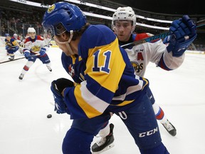 The Edmonton Oil Kings' Ethan Cap (8) battles the Saskatoon Blades' Tristen Robins (11) at Rogers Place, in Edmonton on Jan. 5, 2020.