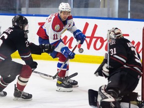 Edmonton Oil Kings forward Dylan Guenther (11) shoots on Red Deer Rebels goaltender Ethan Anders at the Downtown Community Arena in Edmonton on March 21, 2021.