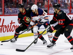 Ottawa Senators defenceman Artem Zub (2) and right wing Evgenii Dadonov (63) check Edmonton Oilers right wing Zack Kassian (44) at the Canadian Tire Centre in Ottawa on Thursday, Oct. 8, 2021.