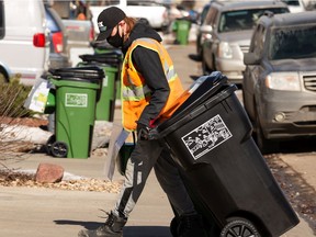 New waste and organics carts are delivered by a city employee in a south Edmonton neighbourhood after a press conference on the Edmonton Cart Rollout on Monday, March 15, 2021.