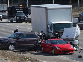 Police investigate a collision that left an officer injured along Whitemud Drive, Monday, April 5, 2021.