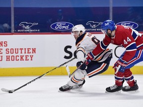 Edmonton Oilers forward Connor McDavid (97) goes by Montreal Canadiens defenseman Joel Edmundson (44) during the second period at the Bell Centre in Montreal on April 5, 2021.