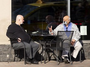 Customers enjoy the warm morning sun at Spinelli Bar Italia on Tuesday, April 6, 2021 in Edmonton. Greg Southam-Postmedia