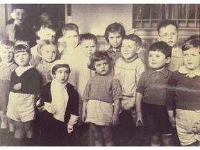 Waiting in a deportation camp in Second World War Brussels, from where Jewish people were sent to concentration and extermination camps in Eastern Europe, are a group of Jewish children under five, including (back row, second and third from left) Jacques Wengrowicz (later Jack Cohen) and four-year-old twin brother Leon Wengrowicz (later Leon Cohen). News of their plight reached Yvonne Nevejean, leader of the Children's National Care Authority in Belgium. The organization fought and saved the lives of some 150 children. The twins were flown to Canada in 1947 in a group of 1,116 youngsters and adopted by Edmonton's Harry and Lillian Cohen.