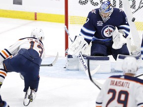 Edmonton Oilers right winger Jesse Puljujarvi (13) score a goal on Winnipeg Jets goaltender Connor Hellebuyck (37) at Bell MTS Place on April 17, 2021.