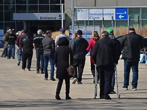 Lineups formed later in the morning for the COVID vaccine on the first day of a lower age group eligibility at the EXPO Centre in Edmonton, April 20, 2021.