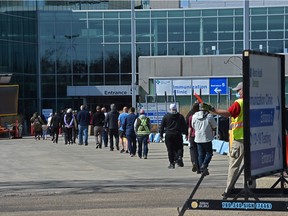 Lineups formed later in the morning for the COVID vaccine on the first day of a lower age group eligibility at the EXPO Centre in Edmonton, April 20, 2021. Ed Kaiser/Postmedia