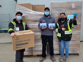 Kamloops Food Bank staff members Darren, Wes, and Deanna receive a shipment of face masks from Edmonton's Ennis Fabrics. The company donated 3.5-million medical grade face masks to Food Banks Canada.