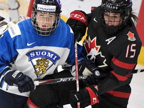 Nelli Laitinen (L) of Finland vies with Melodie Daoust of Canada during the semifinal match Finland v Canada at the IIHF Women's Ice Hockey World Championships in Espoo, Finland on April 13, 2019.