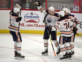 Edmonton Oilers centre Devin Shore (14) celebrates with teammates after scoring a goal against the Ottawa Senators at the Canadian Tire Centre on April 8, 2021.
