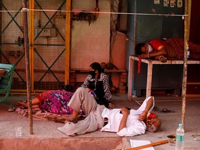 People with breathing problems due to COVID-19 wait to receive oxygen support for free at a Sikh temple in Ghaziabad, India, on April 27, 2021.