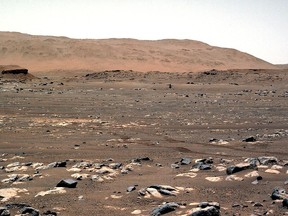 This NASA photo shows NASA's Ingenuity Mars Helicopter achieves powered, controlled flight for the first time on another planet, hovering for several seconds before touching back down on April 19, 2021.