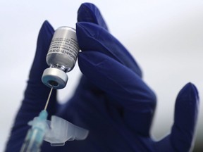 A healthcare worker prepares a Pfizer COVID-19 disease vaccination in Los Angeles, January 7, 2021.