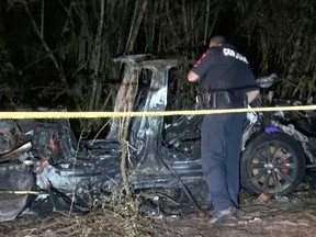 The remains of a Tesla vehicle are seen after it crashed in The Woodlands, Texas, April 17, 2021, in this still image from video obtained via social media. Video taken April 17, 2021.