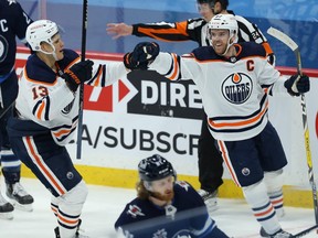 Edmonton Oilers centre Connor McDavid (right) celebrates his goal against the Winnipeg Jets with Jesse Puljujarvi in Winnipeg on April 26, 2021.