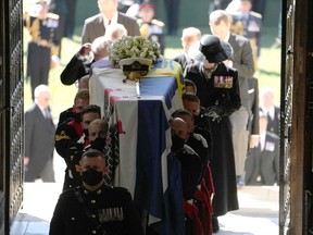Pallbearers carry the coffin into St George's Chapel during the funeral of Britain's Prince Philip, Duke of Edinburgh in Windsor Castle in Windsor, west of London, on April 17, 2021. - Philip, who was married to Queen Elizabeth II for 73 years, died on April 9 aged 99 just weeks after a month-long stay in hospital for treatment to a heart condition and an infection. (Photo by Danny Lawson / POOL / AFP)