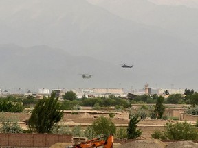 US military helicopters land at a US military base in Bagram, some 50 km north of Kabul on April 29, 2021. (Photo by WAKIL KOHSAR / AFP)