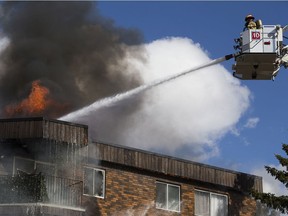 Firefighters battle a large fire at the Castle Court apartments, 14407 121 St. in Edmonton on April 8, 2021.