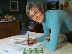 Laureen Rama works on a landscape plan for a nearby home as part of her landscaping company.