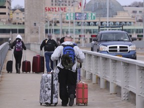 Travellers cross the Rainbow Bridge into Canada on March 18, 2020, in Niagara Falls N.Y.