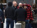 Pastor James Coates, centre, greeted by a group of supporters after being released from the Edmonton Remand Centre on March 22, 2021.