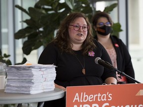 NDP Education Critic Sarah Hoffman, left, and concerned parent Taylor Schroeter with a petition calling on the UCP to scuttle its K-6 curriculum draft. The two appeared at a press conference in Edmonton on Wednesday, April 28, 2021.