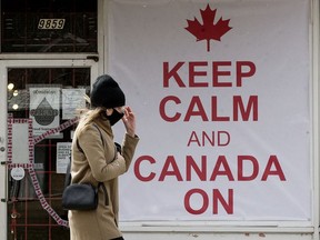 A pedestrian, wearing a mask to protect against COVID-19, makes their way past the O'Canada Gear store, 9859 76 Avenue, in Edmonton Thursday April 22, 2021. Photo by David Bloom