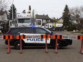 Police work at the scene of a fatal traffic collision near 122 Street and 143A Avenue, in Edmonton, Tuesday, April 27, 2021.