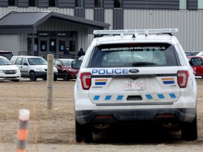 The RCMP watch as parishioners arrive for Easter Sunday service at GraceLife Church in Parkland County on April 4, 2021.