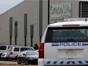 The RCMP watch as parishioners arrive for Good Friday Service at GraceLife Church, in Edmonton Friday April 2, 2021. The church continues to defy COVID-19 public health orders and restrictions.