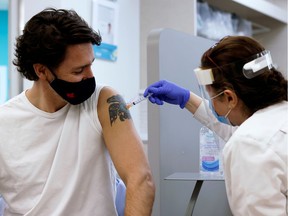 Prime Minister Justin Trudeau is inoculated with AstraZeneca's vaccine against COVID-19 at a pharmacy in Ottawa on April 23, 2021.