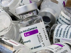 FILE PHOTO: Empty vials of Oxford/AstraZeneca's COVID-19 vaccine are pictured amid a vaccination campaign in Bierset, Belgium March 17, 2021. REUTERS/Yves Herman/File Photo ORG XMIT: FW1