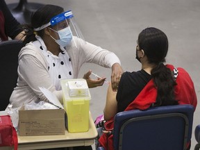 A nurse delivers a COVID-19 vaccination shot at the First Nations Vaccination Clinic at the River Cree Resort and Casino, near Edmonton Tuesday April 13, 2021. File photo.