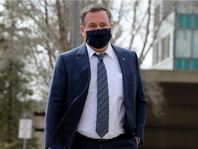Alberta Premier Jason Kenney walks through the Alberta legislature grounds on April 8, 2021.