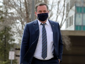 Alberta Premier Jason Kenney walks through the Alberta Legislature grounds to the Federal Building, in Edmonton Thursday April 1, 2021.