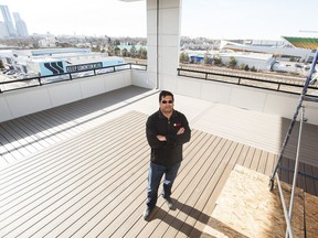 Rohit Gupta, of Rohit Group of Companies, stands on a rooftop patio at Stadium Yards. This multi-use development is situated so residents can easily access the Stadium LRT station, the Commonwealth Stadium (top right) and the river valley. The buildings include rooftop patios for residents' use.