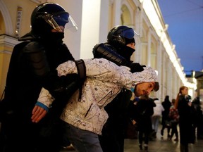 FILE PHOTO: A demonstrator is taken away by law enforcement officers during a rally in support of jailed Russian opposition politician Alexei Navalny in Saint Petersburg, Russia April 21, 2021. REUTERS/Anton Vaganov/File Photo ORG XMIT: FW1