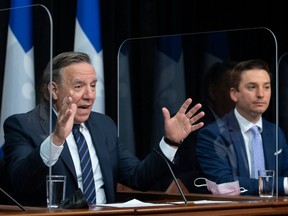Quebec Premier Francois Legault, left, speaks during a news conference after tabling Bill 96, at the national assembly in Quebec City on May 13.