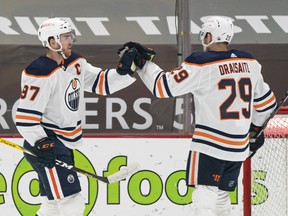 Connor McDavid (97) of the Edmonton Oilers celebrates with teammate Leon Draisaitl (29) after scoring a goal against the Vancouver Canucks at Rogers Arena on May 3, 2021.