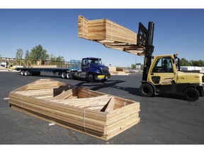 A worker loads finished  trusses for homes onto a truck at Wasatch Truss in Utah. Lumber prices have sky rocketed along with supply shortages the last several months have plagued the construction industry.