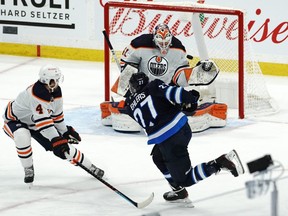 Nikolaj Ehlers #27 of the Winnipeg Jets takes a shot against Mike Smith #41 of the Edmonton Oilers during the overtime period in Game Four of the First Round of the 2021 Stanley Cup Playoffs on May 24, 2021 at Bell MTS Place in Winnipeg, Manitoba, Canada.