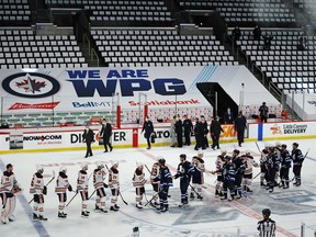 The Winnipeg Jets shake hands with the Edmonton Oilers following their victory in Game 4 of the first round of the 2021 Stanley Cup playoffs on May 24, 2021, at Bell MTS Place in Winnipeg.