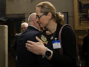 Edmonton Police Service Chief Dale McFee is hugged by LGBTQ activist Marni Panas after McFee apologized to the LGBTQ2S+ community at Edmonton Police Headquarters, in Edmonton Friday May 3, 2019. The apology is part of a reconciliation process with the EPS and members of the lesbian, gay, bisexual, trans, queer, and two-spirit community.