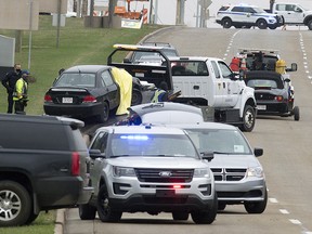 Police and emergency responders work at the scene of a fatal shooting along Baseline Road between Highway 21 and Cloverbar Road, in Sherwood Park on Friday, May 7, 2021. One person has died and another was transported to hospital. A suspect has been arrested.