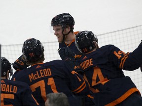 The Edmonton Oilers' Connor McDavid (97) celebrates his 100th point on the way to a 4-3 win over the Vancouver Canucks at Rogers Place in Edmonton on Saturday, May 8, 2021.