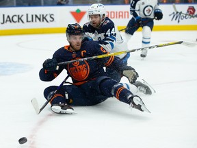 Edmonton Oilers captain Connor McDavid (97) battles the Winnipeg Jets’ Josh Morrissey (44) during their North Division playoff series opener at Rogers Place in Edmonton on Wednesday, May 19, 2021.