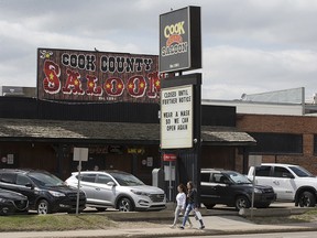 Pedestrians make their way past the closed Cook County Saloon, 8010 Gateway Blvd., in Edmonton Wednesday May 26, 2021. On Wednesday Alberta announced it's reopening plan to remove COVID-19 restrictions. Photo by David Bloom