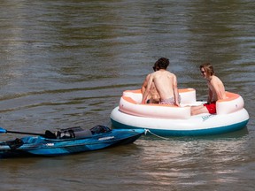 Young men take to the North Saskatchewan River on a hot day from the new dock at Emily Murphy Park in Edmonton, on Sunday, May 30, 2021. Photo by Ian Kucerak