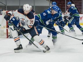 Vancouver Canucks defenseman Quinn Hughes (43) checks Edmonton Oilers forward Ryan McLeod (71) in the third period at Rogers Arena. Oilers won 5-3 on May 4, 2021.